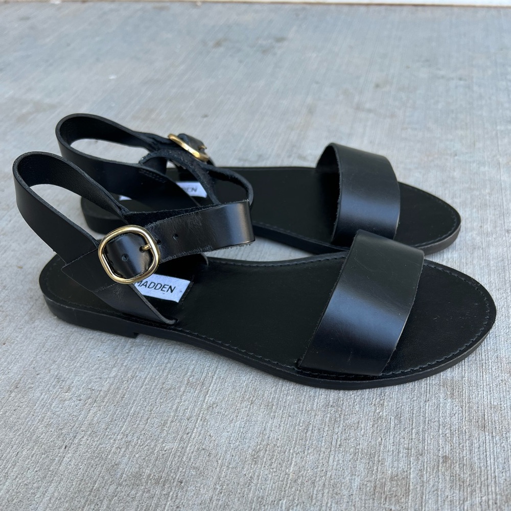 Black leather two strap Steve Madden Sandals flats.